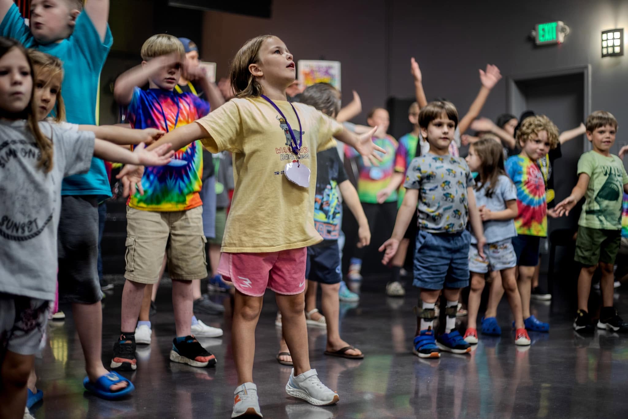 Children worshiping with arms outstretched during Hope Kids at Hope House Church