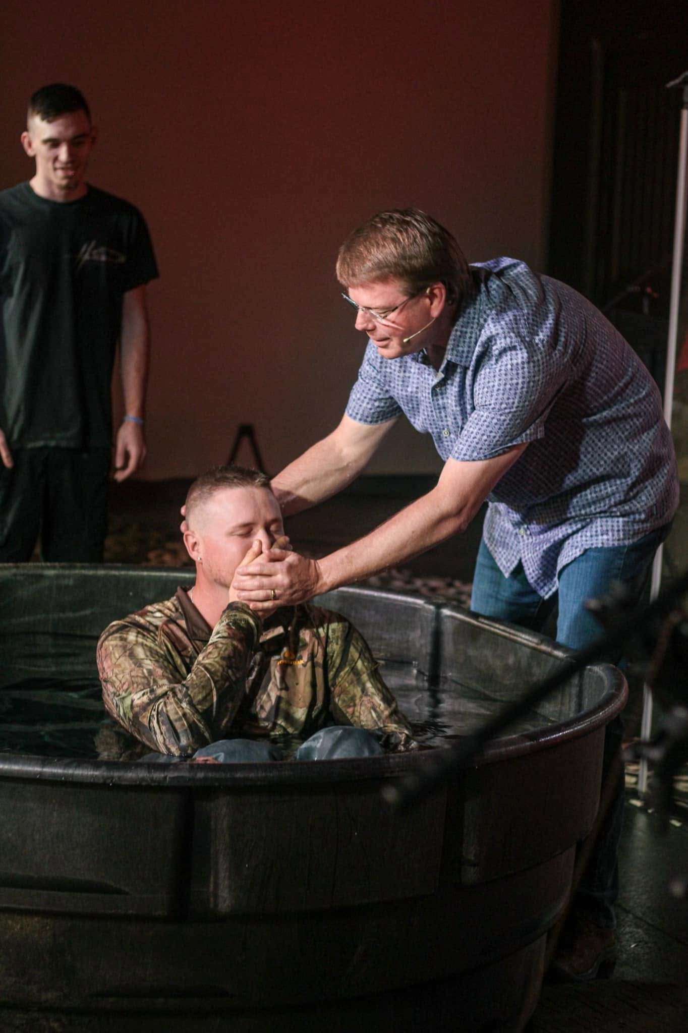 A pastor baptizing a man during a Sunday service at Hope House Church